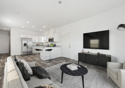 Model open living room with gray couch at Desert Valley Oasis Manufactured Homes in Mesa Arizona