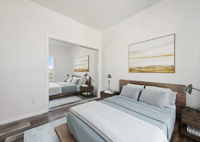 Model bedroom with mirror door closet at Desert Valley Oasis Manufactured Homes in Mesa Arizona